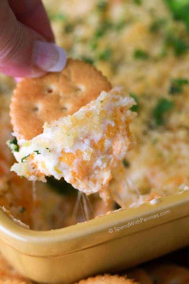 crackers being dipped into Jalapeno Popper Dip