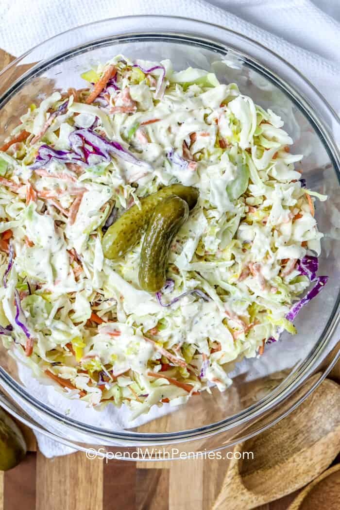 dill pickle coleslaw garnished with pickles