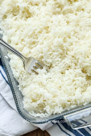 baked rice in a casserole dish with a fork