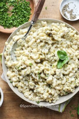 overhead of Pesto Mac and Cheese in a serving bowl with a spoon