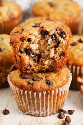 Banana Chocolate Chip Muffin with a bite taken from it with muffins behind