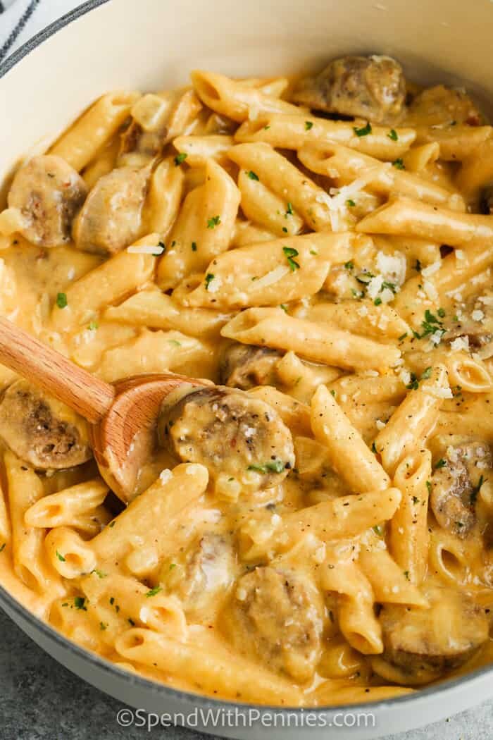 Stove Top 3 Cheese Pasta with Sausage with a wooden spoon