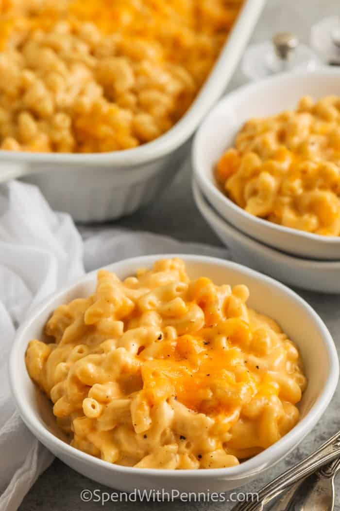 Homemade Mac and Cheese Casserole in bowls with dish full in the back