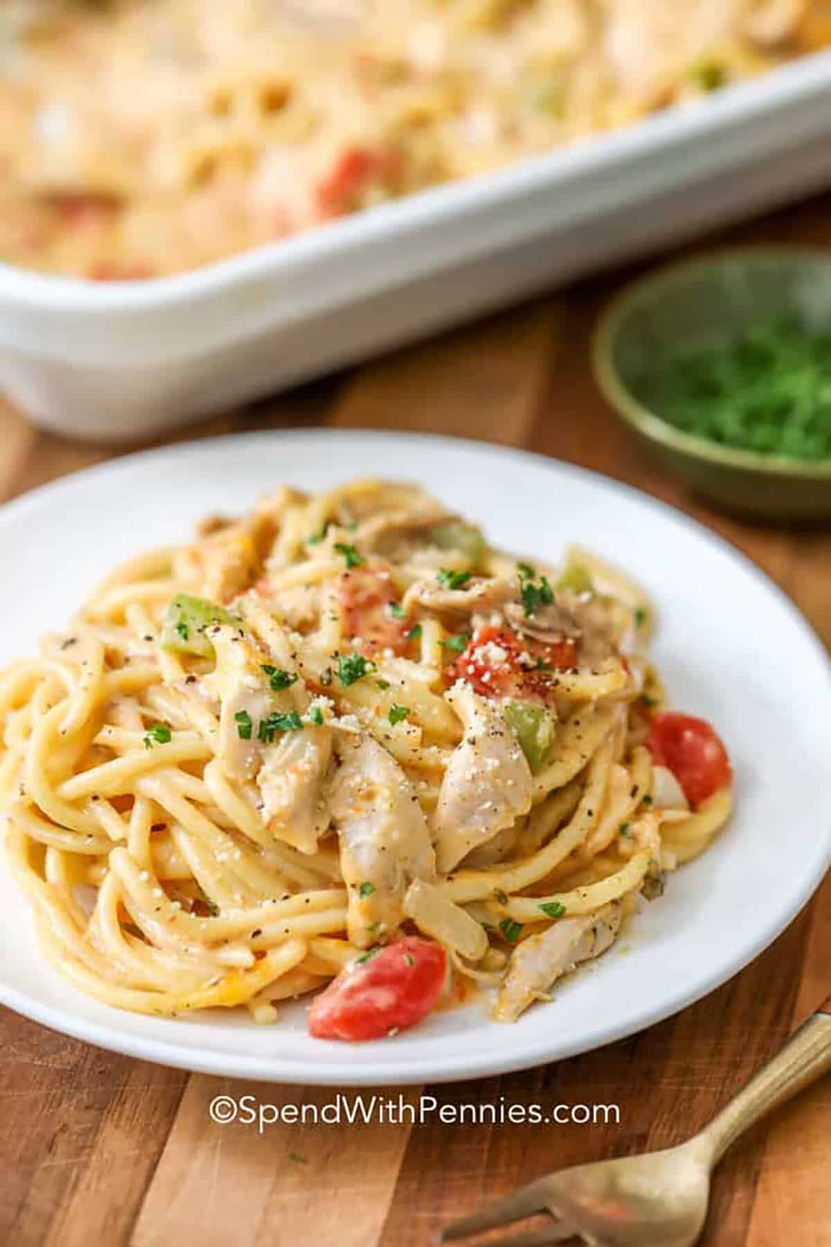 plated Chicken Spaghetti with casserole dish in the back full