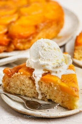 Peach Upside Down Cake on a plate with ice cream