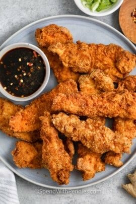 plated chicken tenders and sauce to make Ginger Honey Garlic Chicken Tenders