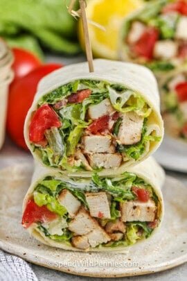 Chicken Caesar Wrap cut in half on a plate with a toothpick